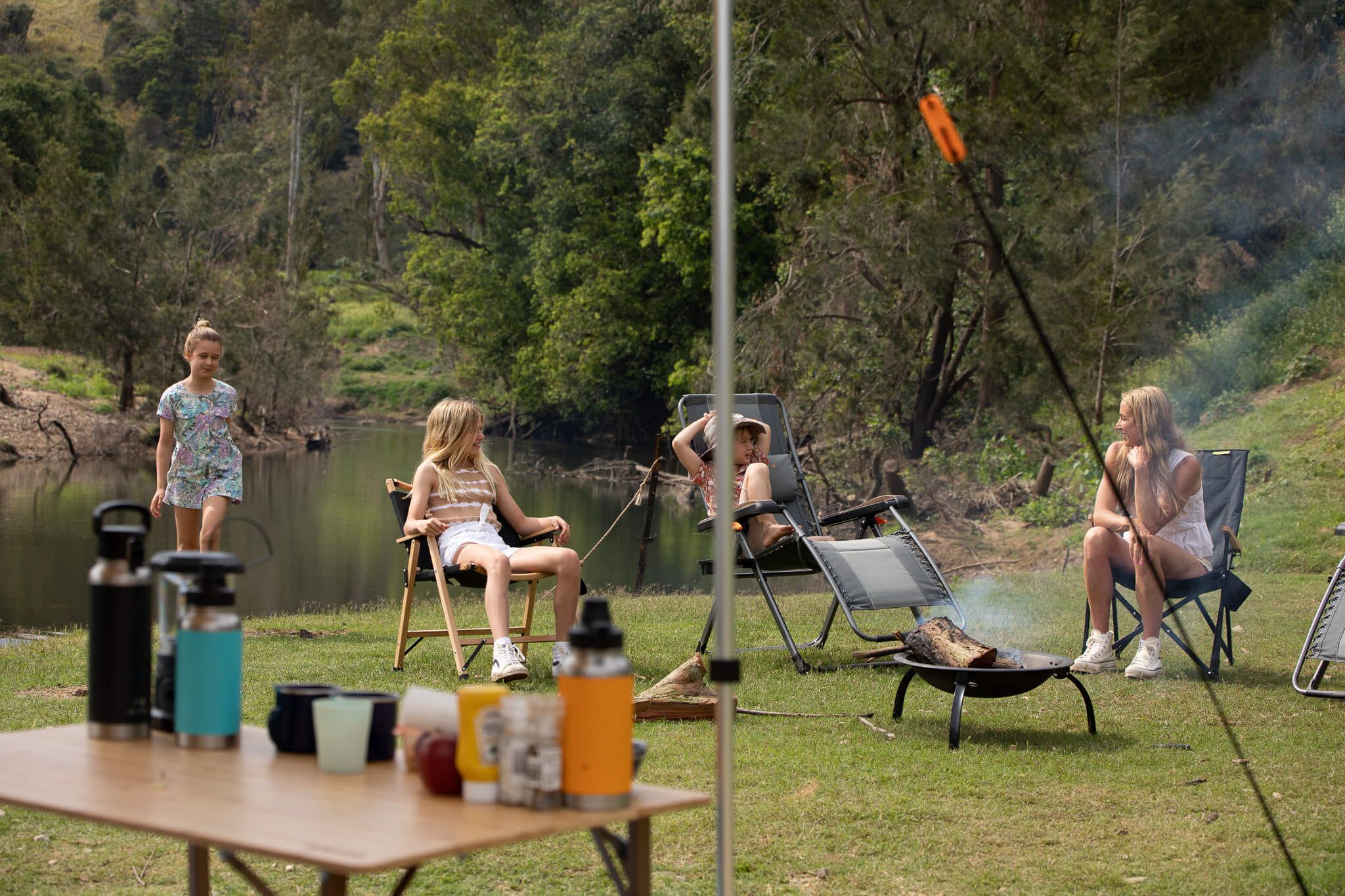 Chairs and loungers Family sitting down at camp